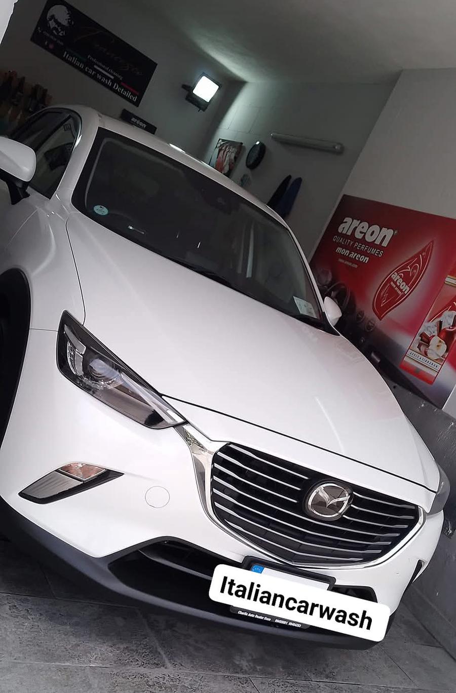 White Mazda CX-3 after a wash, inside the garage
