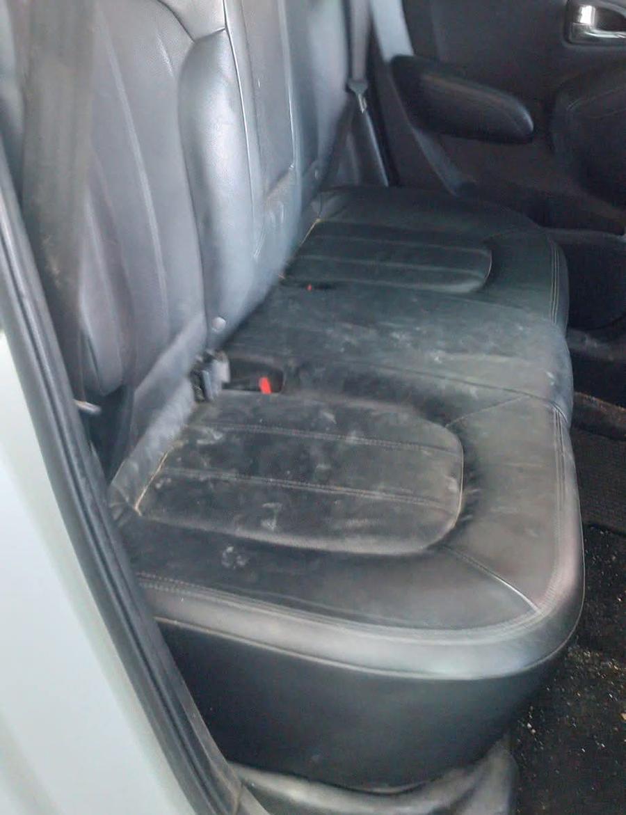 Dirty black leather rear seats before cleaning